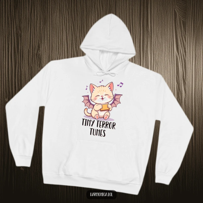 Funny hoodie with a playful kitten batting at a harmonica, designed for ultimate comfort and feline fun.